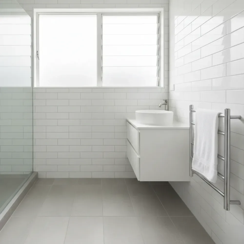 completed-ensuite-renovation-result-auckland Completed Auckland ensuite renovation with grey stone-look tiles, white subway walls, vessel basin, and chrome heated towel rail.